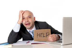 Bald Latin Business Man Over Worked Holding A Help Sign